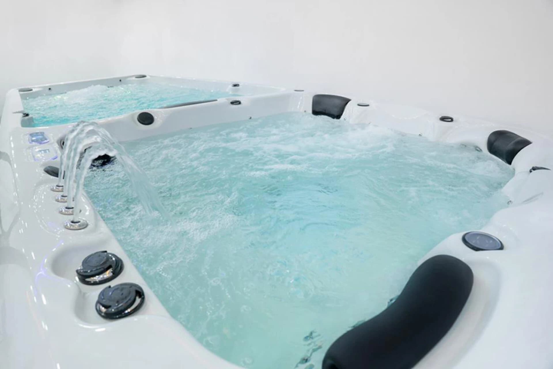 Swim spa with an exercise area and adjoining spa seats