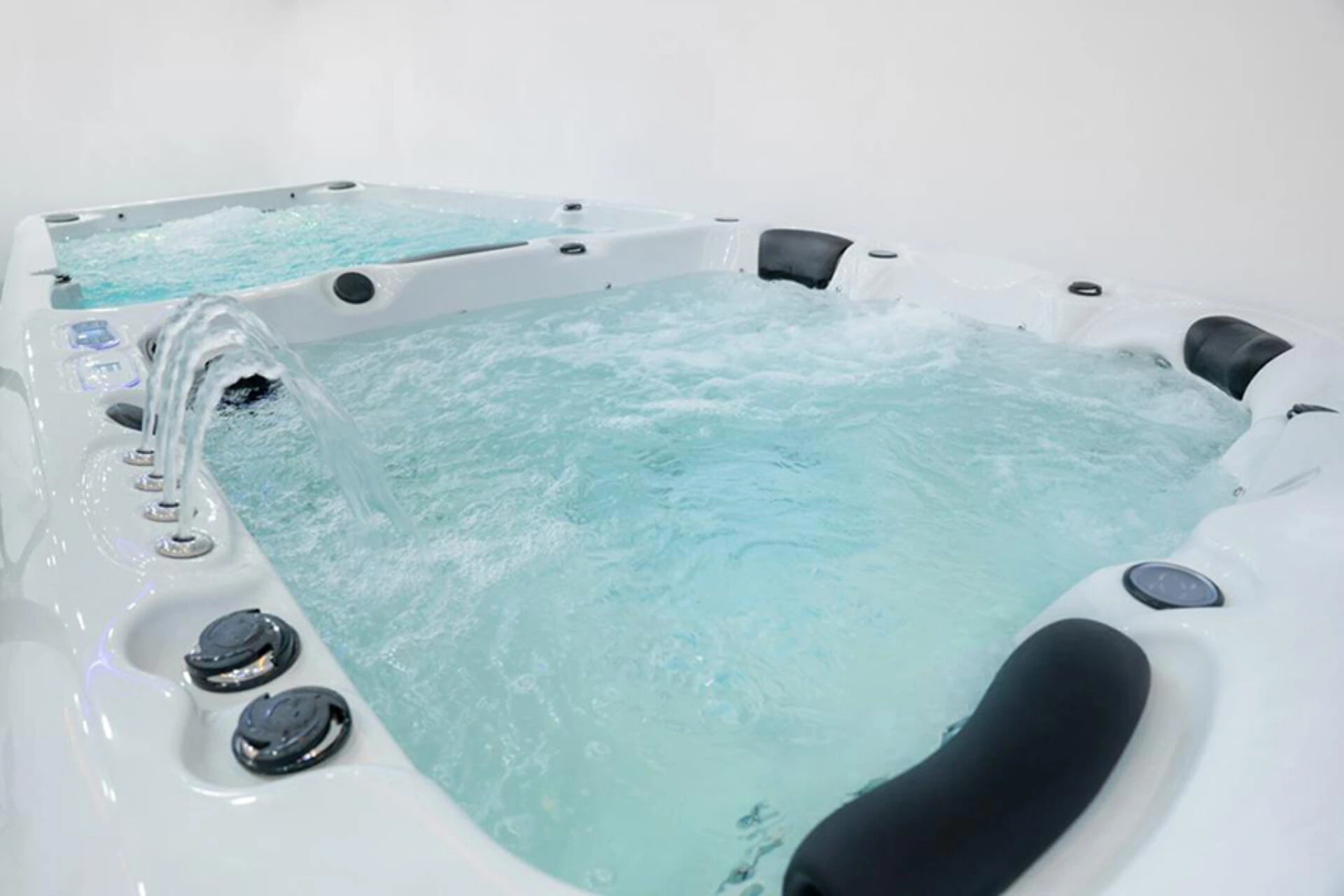 Swim spa with an exercise area and adjoining spa seats