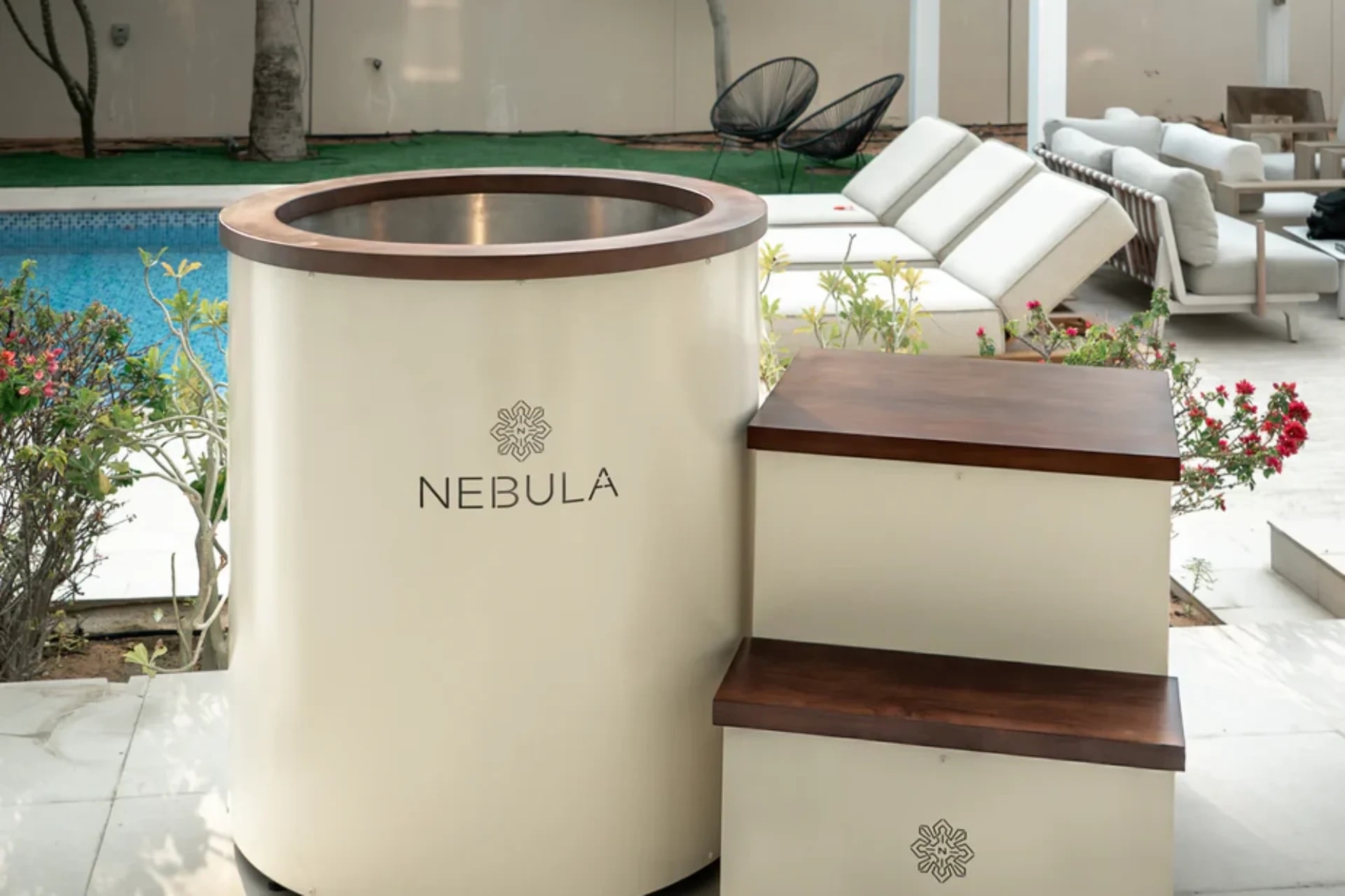 Cream Barrel ice bath with timber-topped steps beside a pool